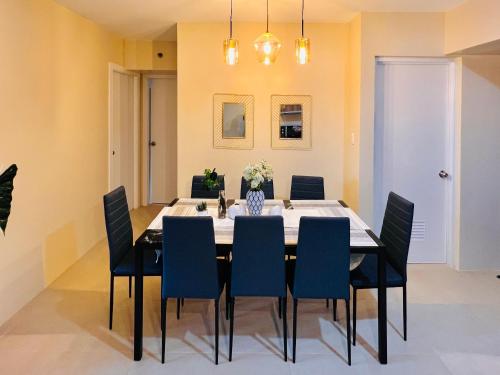 a dining room with a table and chairs at * *P Fantastic 2BR Option for 8 in Iloilo City