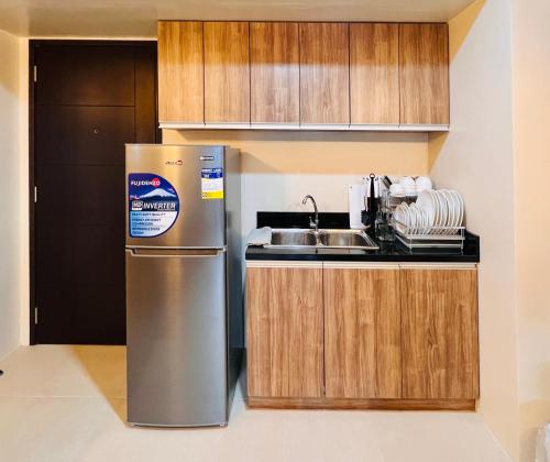 a kitchen with a stainless steel refrigerator and a sink at * *P Fantastic 2BR Option for 8 in Iloilo City