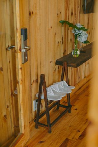 a wooden room with a chair and a table at Lavender Dalat Hotel and Resorts in Da Lat