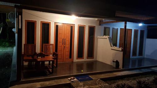 a room with a table and some windows at night at Amoryg Resort and Dive Raja Ampat in Pulau Mansuar