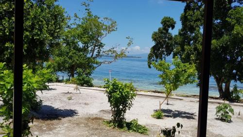 a view of the beach from a window at Amoryg Resort and Dive Raja Ampat in Pulau Mansuar