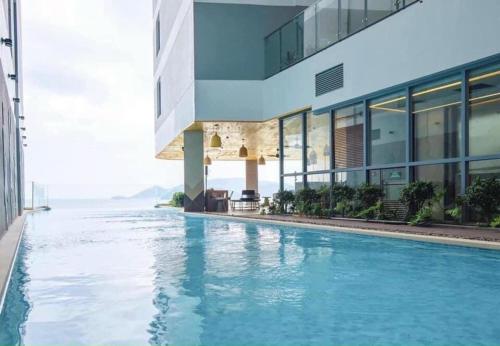 a swimming pool in front of a building at Dinh’s Aparment in Tuy Hoa