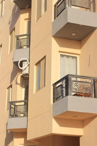 a building with balconies on the side of it at اجمل شاليه بقرية بلو باي بمرسى مطروح مكيف غرفتين ورسيبشن best chalet 2 room marsa matrouh blue bay village in Marsa Matruh