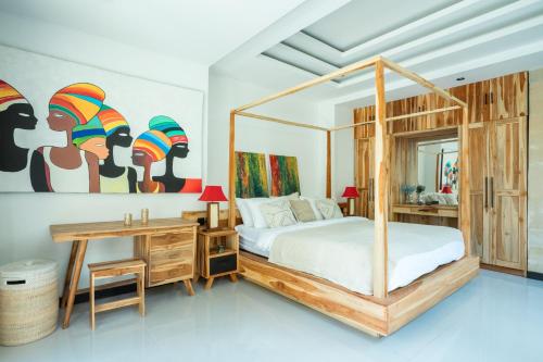 a bedroom with a bed and a desk and a mirror at Sunrise Villa in Payangan