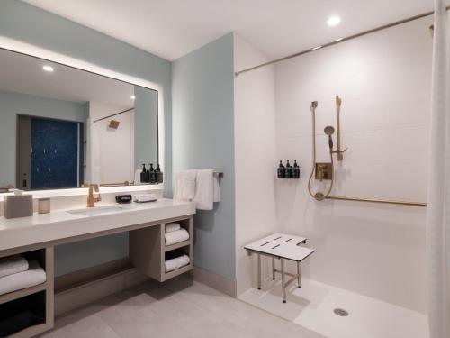 a bathroom with a sink and a shower at Hotel Indigo - Panama City Marina by IHG in Panama City