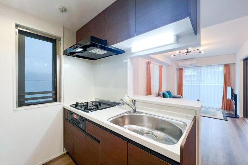a small kitchen with a sink and a window at aLATO Kinshicho in Tokyo