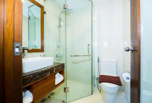 a bathroom with a shower and a toilet and a sink at Avatar Danang Hotel in Da Nang