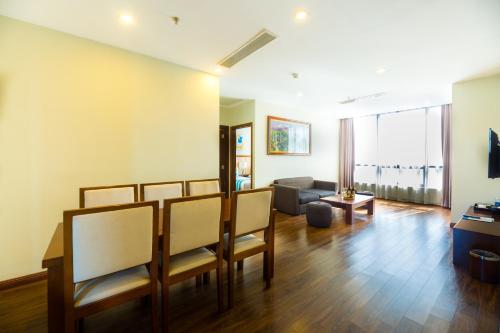 a living room with chairs and a couch at Avatar Danang Hotel in Da Nang