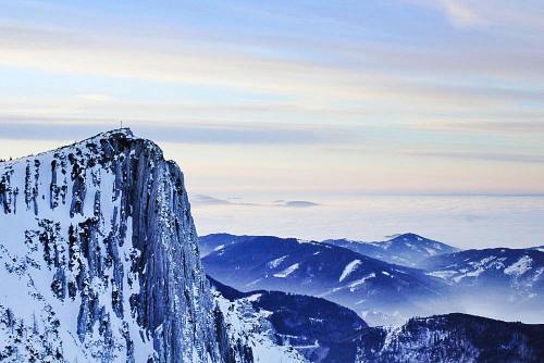 a person standing on the top of a snow covered mountain at Feriendorf am Feuerkogel, Ebensee in Ebensee