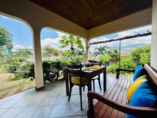 a screened in porch with a table and chairs at The Views Kandy - 360 Mountain View in Kandy