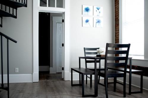 a dining room with two chairs and a table at Main Street Balcony Apartment For up to 8 guests! in St. Charles