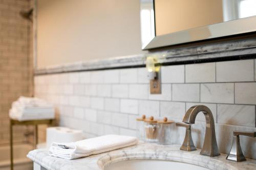 a bathroom counter with a sink and a mirror at Private Basement Retreat in St. Charles