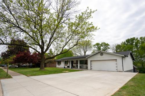 a house with a white garage and a driveway at Private Basement Retreat in St. Charles