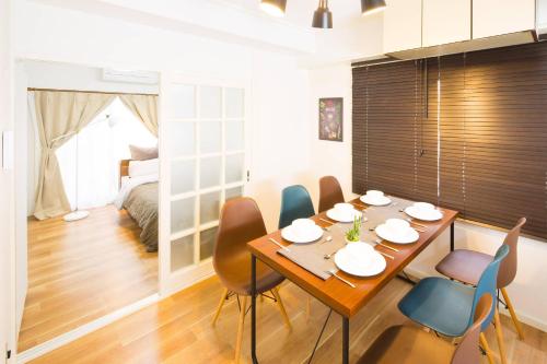 a dining room with a table and chairs at Tsukimura Building in Tokyo