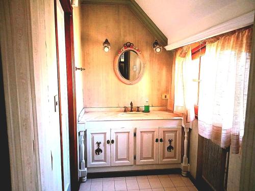 a bathroom with a sink and a mirror at Casa Bravo in Mendoza