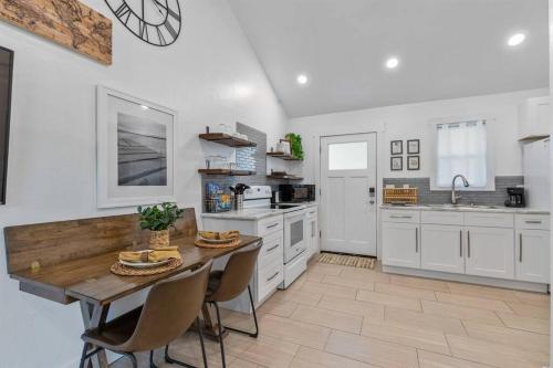 a large kitchen with a wooden table and chairs at Cozy Cottage • King Bed • Grove • Kayaks • Boat Parking in Grove