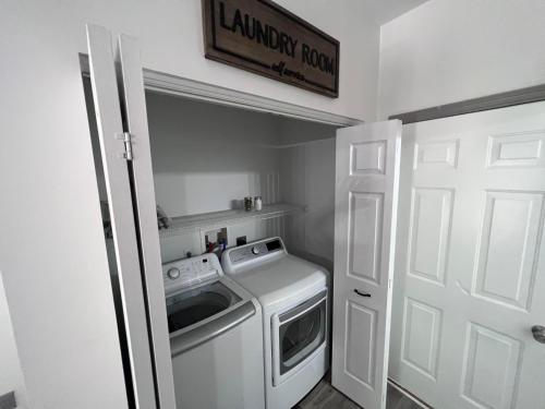 a small laundry room with a washer and dryer at Springhurst Serenity Fresh 4BR Getaway in O'Fallon