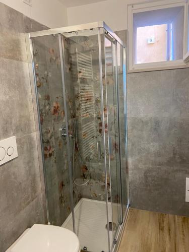 a shower stall in a bathroom with a toilet at Home Sweet Home in Foligno