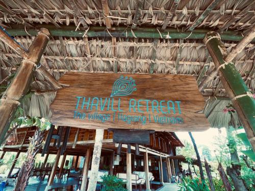 a sign for a hawaiian resort with a restaurant at Thavill Retreat HaGiang in Ha Giang