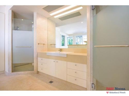 a large bathroom with a sink and a mirror at 14 Little Cove Road, Little Cove in Noosa Heads