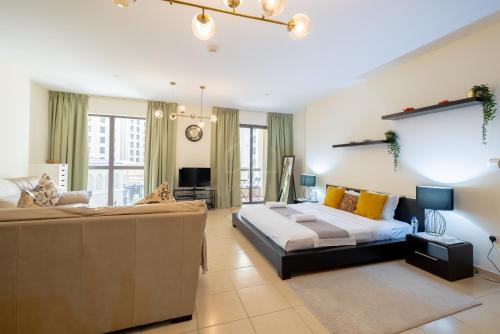 ein Wohnzimmer mit einem Bett und einem Sofa in der Unterkunft Perfect studio near the beach JBR in Dubai