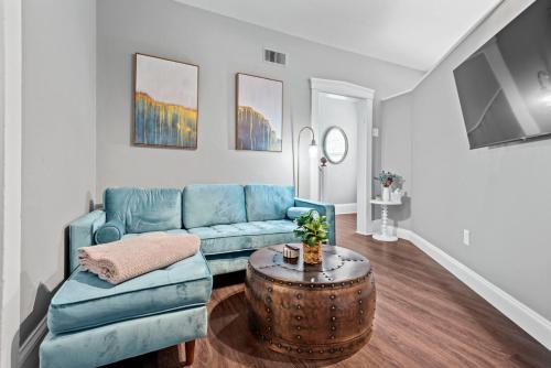 a living room with a blue couch and a table at Main Street Living! 2 Bedroom Unit right On Main! in St. Charles