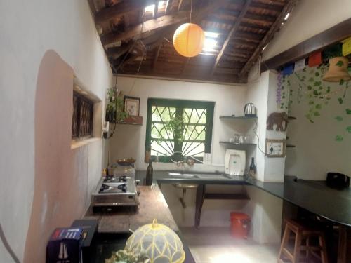a kitchen with a sink and a stove in it at The Wild Flower! in Anjuna