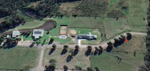 an aerial view of a farm with a truck in a field at Excellent campsite Hunter Valley in Pokolbin