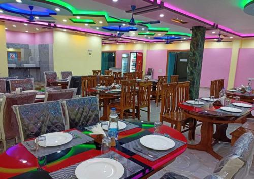 a dining room with tables and chairs and lights at ST Apple Beach Resort Mandarmani in Mandarmoni