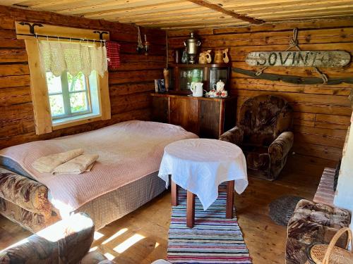 a bedroom with a bed and a table in a cabin at Suurekivi külalistemaja in Reigi