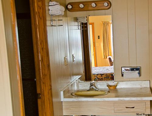a bathroom with a sink and a mirror at Inn Town Motel in Waupun