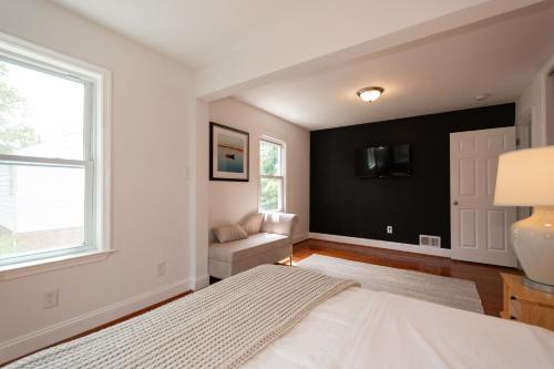 a bedroom with a bed and a window and a couch at Takoma Park Home ~ 6 Mi to the National Mall! in Takoma Park