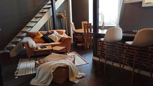 ein Wohnzimmer mit einem Stuhl und einer Treppe in der Unterkunft MaxiMar Apartment With Sauna in Valga