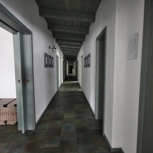 a hallway of a building with white walls and a ceiling at Penzion U vinaře in Velké Bílovice
