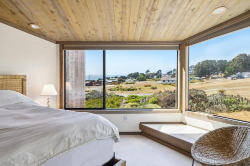 a bedroom with a bed and a large window at Mar Vista in Bodega Bay