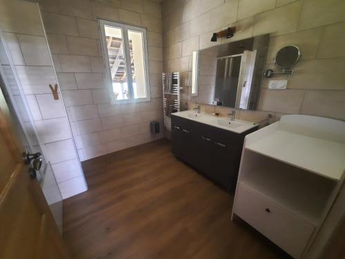 a bathroom with a sink and a mirror at Gîte Brequat - Pyrénées Atlantique in Lestelle-Bétharram