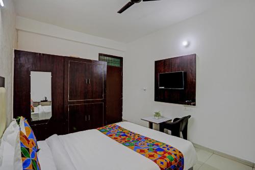 a hotel room with a bed and a tv at Shree Hotel in Lucknow