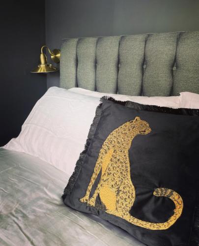 a blanket with a leopard on it on a bed at No.123 The Old Post House in Scalby
