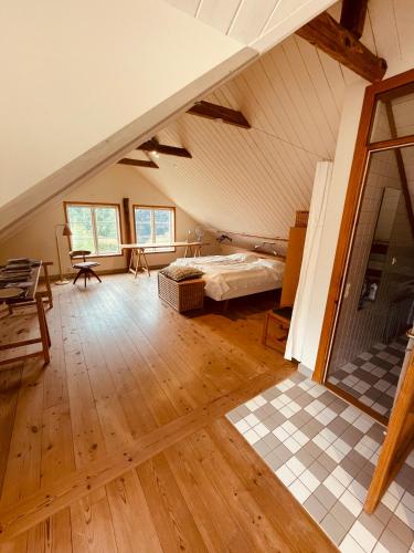a bedroom with a bed in a attic at Skogslund, Skåne in Veberöd