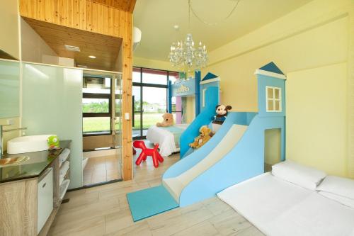 a kids room with a slide in the middle at Pink Castle House in Dongshan