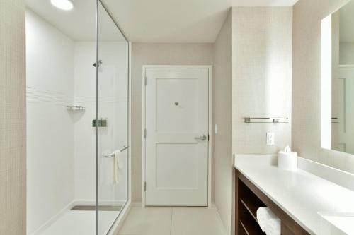 a bathroom with a glass shower and a sink at Residence Inn by Marriott Eau Claire in Eau Claire