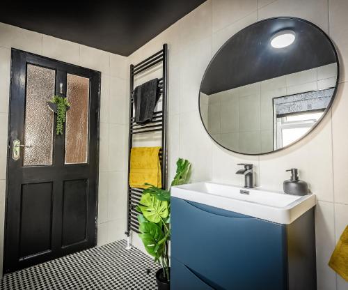 a bathroom with a sink and a mirror at City Escape Waterford City Sleeps 6 in Waterford