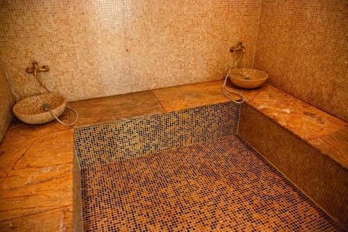 a dirty bathroom with a tub and a sink at Dinaburg SPA Hotel in Daugavpils