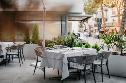 a table and chairs on the patio of a restaurant at J44 Lifestyle Hotel in Lido di Jesolo