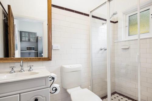 a bathroom with a toilet and a sink and a shower at Beachside Cottage Glenelg Sth in Glenelg