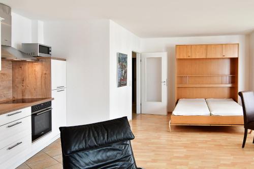 a kitchen with a couch and a bed in a room at Miramar-App-21 in Ahlbeck