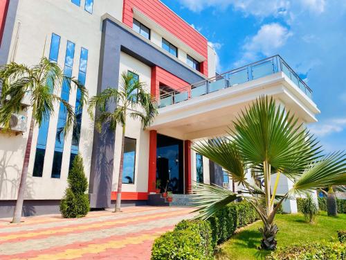 a building with palm trees in front of it at Mauryan's Premier in Gaya