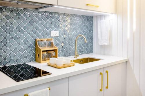 a kitchen with a sink and a counter top at KILA Homes at Pine Suites Tagaytay in Tagaytay