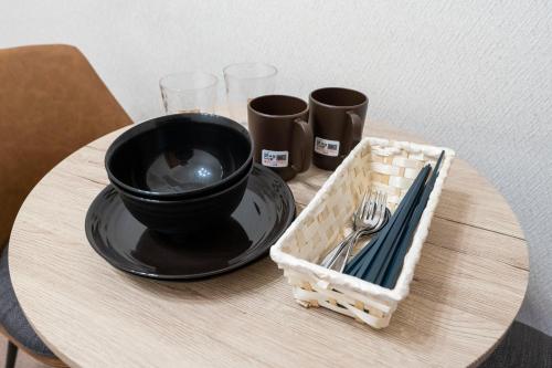 a table with a black bowl and a basket on it at Fujiterrace Yoga in Tokyo