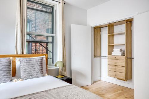 a bedroom with a bed and a window at Soho 3br w wd elevator nr cafes restaurants NYC-1043 in New York